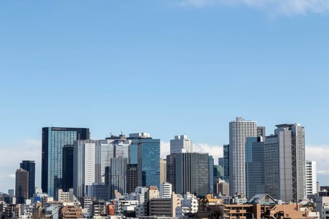 Modern architecture, view over the rooftops of the city to the glass facades of skyscrapers against