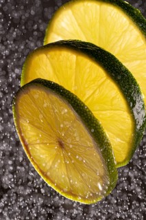 Three lime slices with drops of water