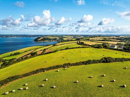 Farms and Fields over St Mawes from drone, Carrick Roads, River Fal, Falmouth, Cornwall, UK