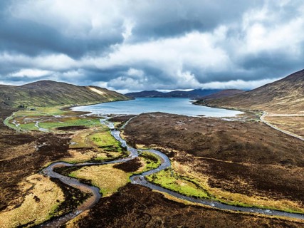 View over Eas a' Bhradain Waterfall from drone, Red Cuillin mountains, Loch Ainort, Isle of Skye,