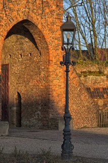 Classic lantern in front of historic brick building (Linn Castle gate) in the light show, Krefeld
