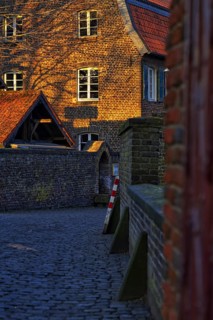 Old brick building in warm evening light with striking gable, Krefeld