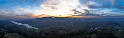 Panorama of Sunset over Mountains and Coniston Water from drone, Lake District National Park,