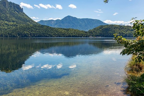 Clear water at Lake Altaussee with mountain landscape under a blue sky, Altaussee, Styria, Austria