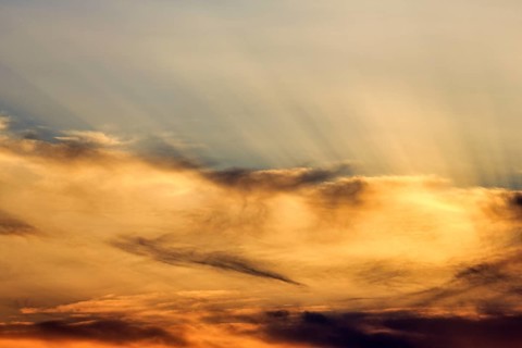 Sunset behind cloud cover, sunbeams, Oia, Thira, Santorini, Cyclades, Greece