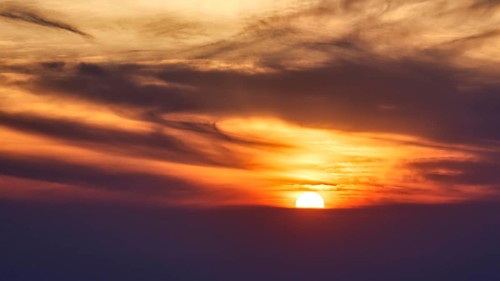 Sunset behind clouds, blurred, Oia, Thira, Santorini, Cyclades, Greece