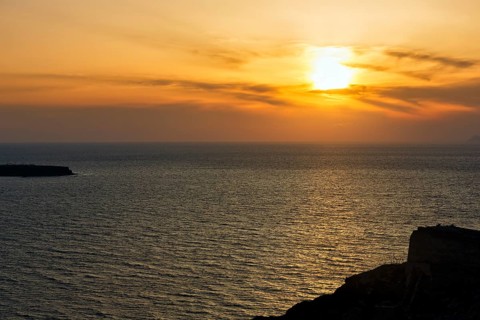 Evening sun behind Cirrus, sunset by the sea, Oia, Thira, Santorini, Cyclades, Greece