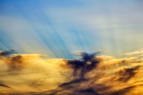 Sunset behind cloud cover, sunbeams, Oia, Thira, Santorini, Cyclades, Greece