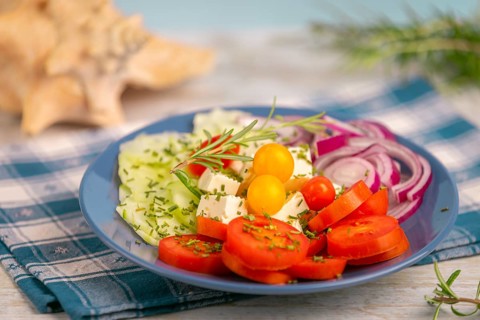 Plate with vegetables and feta in a maritime atmosphere