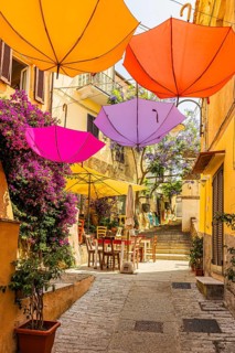 Coloured umbrellas span the Via Cavour, Capoliveri, Elba Island, Tuscan Archipelago National Park,