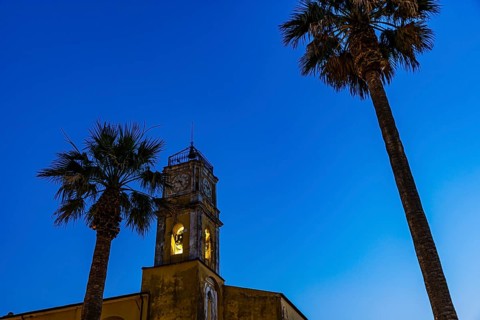Illuminated steeple of the Madonna del Carmine church, night shot, Porto Azzurro, Elba Island,