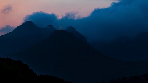 Illuminated steel cross on the summit of Monte Mar di Capanna, above Porto Azzurro, night shot,