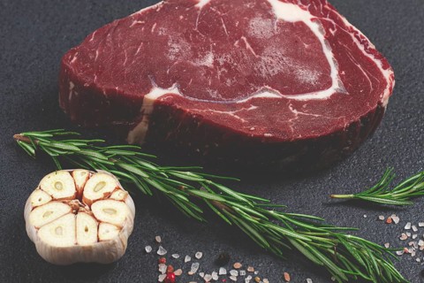 Raw steak, beef steak, rib eye steak, on the table, top view, no people, on a dark background