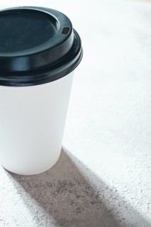 Coffee cup on the table, minimalistic design, disposable tableware, daylight