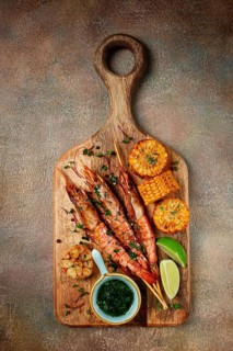 Langoustines on skewers, shrimp kebab, with fried corn, spices and herbs, homemade, no people