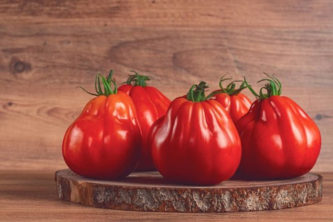 Khinkali tomatoes, on a wooden cutting board, wooden background, no people