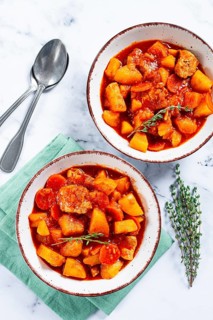 Meat goulash with potatoes and carrots, sweet peppers, in a saucepan, top view, traditional