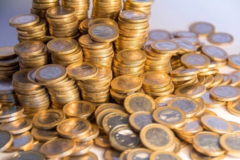 Lots of stacked 1 euro coins