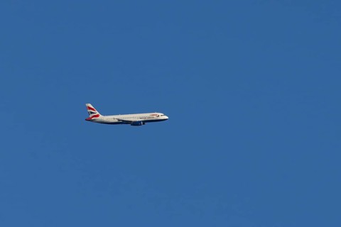 Airbus A320-232 jet passenger aircraft of British Airways airlines in flight in a blue sky, London,