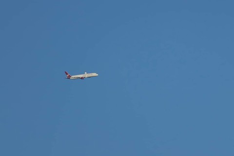 Boeing 787-9 Dreamliner jet passenger aircraft of Virgin Atlantic airlines in flight in a blue sky,