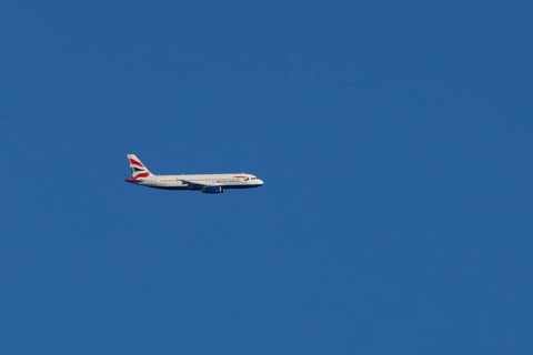 Airbus A320-232 jet passenger aircraft of British Airways airlines in flight in a blue sky, London,