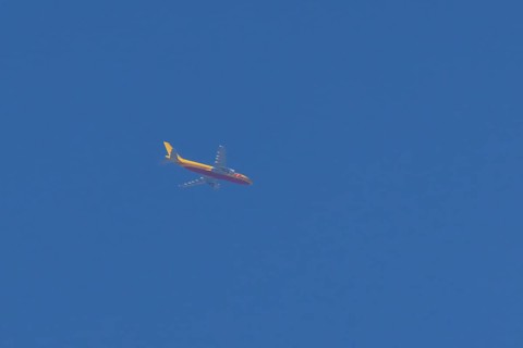 Boeing 767 jet aircraft of DHL cargo airlines in flight in a blue sky, England, United Kingdom