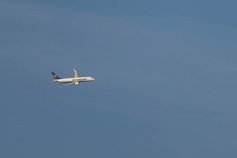 Boeing 737 jet passenger aircraft of Ryanair airlines in flight in a blue sky, Rome, Italy