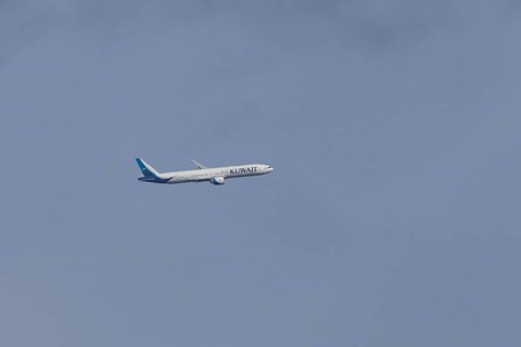Boeing 777 jet passenger aircraft of Kuwait airlines in flight in a blue sky, England, United