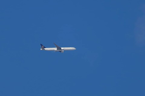 Boeing 777 jet passenger aircraft of Saudi airlines in flight in a blue sky, England, United