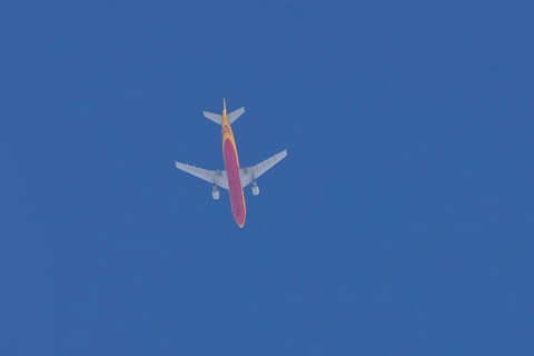 Boeing 767 jet aircraft of DHL cargo airlines in flight in a blue sky, England, United Kingdom