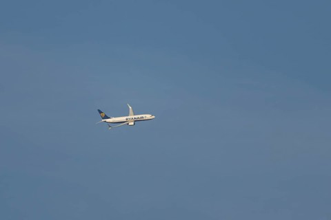 Boeing 737 jet passenger aircraft of Ryanair airlines in flight in a blue sky, Rome, Italy