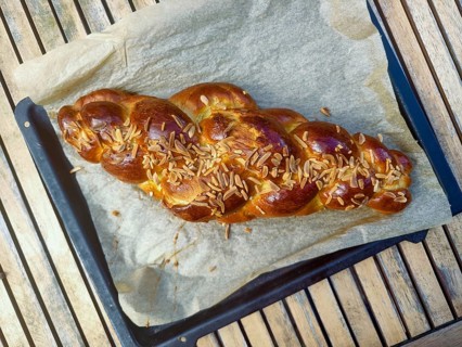 Braided yeast plait with almond slivers on a baking tray with baking paper Lower Austria Austria