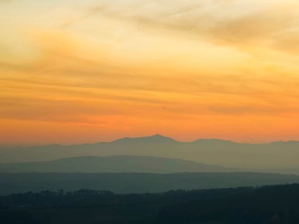 Silhouettes of mountains in the soft light of a pastel-coloured sunset Leiserbergen Weinviertel