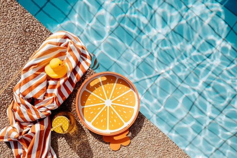 Pool edge with orange, summery props