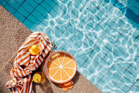 Pool edge with orange, summery props