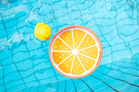 Orange tray and yellow rubber duck in the pool