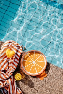 Pool edge with orange, summery props