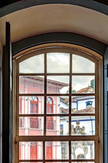 View of the city of Ouro Preto through an old window in a colonial mansion, Ouro Preto, Minas