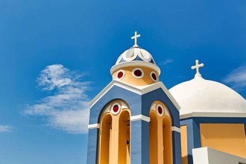 Catholic Church of Saint Stylianos, colourful facade, domes, Fira, Thira, Santorini, Cyclades,