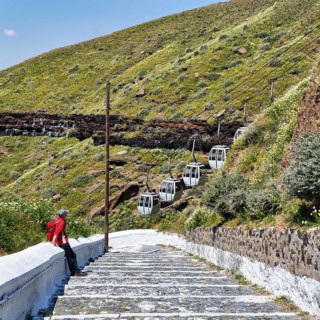 Hiker on stairs, old road to the harbour of the capital Fira, cable car, Thira, Santorini,