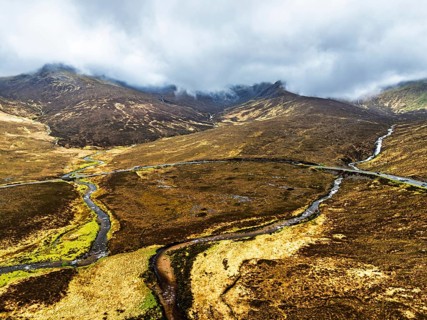 Eas a' Bhradain Waterfall from drone, Red Cuillin mountains, Loch Ainort, Isle of Skye, Scotland,