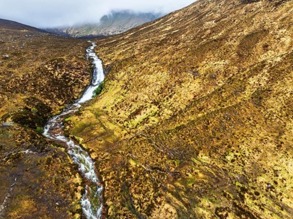 Eas a' Bhradain Waterfall from drone, Red Cuillin mountains, Loch Ainort, Isle of Skye, Scotland,