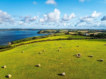 Farms and Fields over St Mawes from drone, Carrick Roads, River Fal, Falmouth, Cornwall, UK