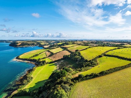 Farms and Fields over St Mawes from drone, Carrick Roads, River Fal, Falmouth, Cornwall, UK