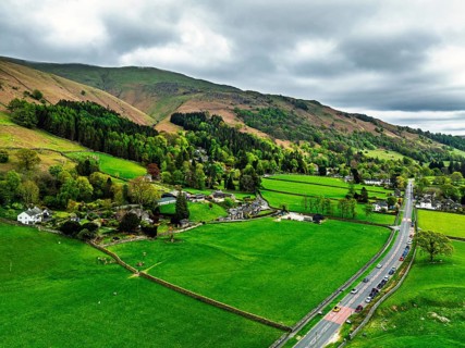 Farms and Mountains over road A591 from a drone, Grasmere Lake, Grasmere, Ambleside, Lake District,