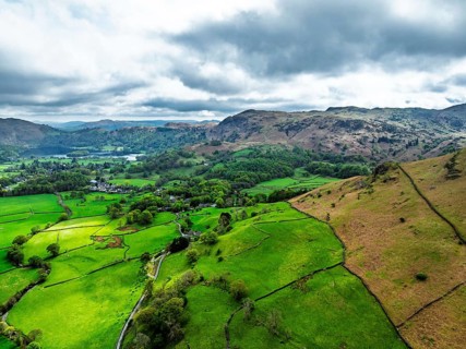 Farms and Mountains over road A591 from a drone, Grasmere Lake, Grasmere, Ambleside, Lake District,