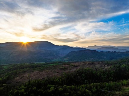 Sunset over Mountains and Coniston Water from drone, Lake District National Park, Cumbria, England,