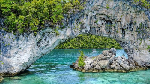 View through rock arch Natural Arch in lagoon of in island paradise island state Palau in the