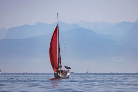 Sailing ship travelling on Lake Constance. The Swiss Alps in the background. Immenstaad,