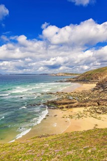 Rolling waves to the beach at a rocky coastline a beautiful sunny day by the sea, Crozon peninsula,